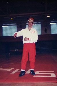 Will Strohl wearing a crown in front of the crowd at a wrestling match